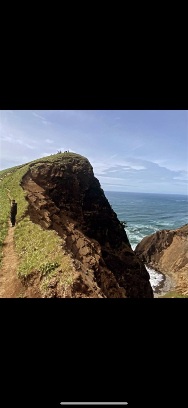 Belinskii on a coastal cliff trail above the ocean